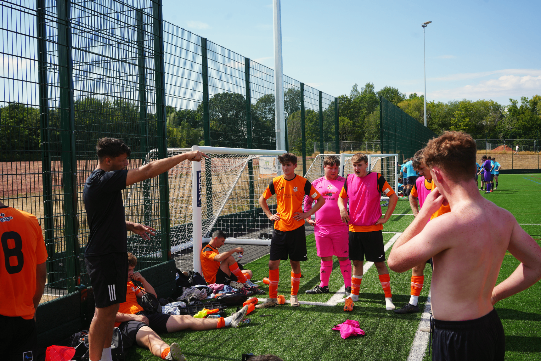 Manager Hugh Brookes delivering instructions to the Burghill Rangers squad by the goalpost during the Wellington FC friendly